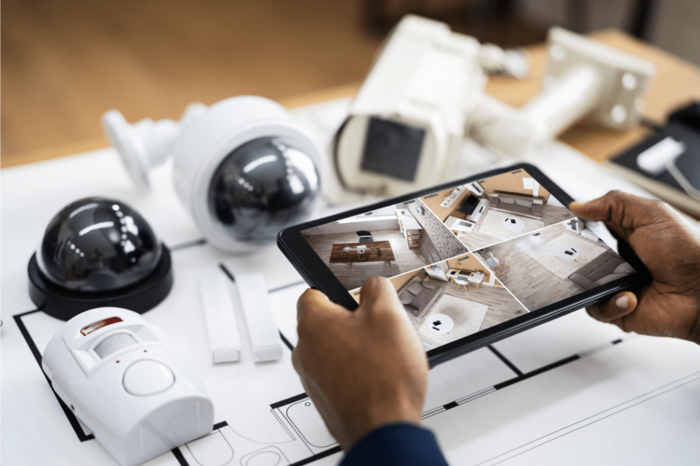 Person using consumer elctronics tablet to watch security cameras of home
