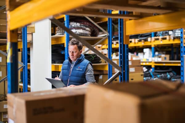 FIDELITONE employee checking inventory to reduce warehouse costs