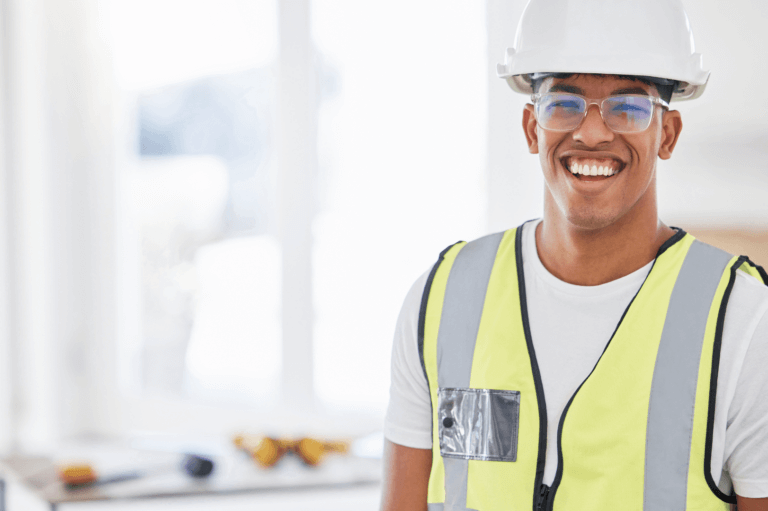 Maintenance, repair, and operations technician wearing hard hat and yellow vest