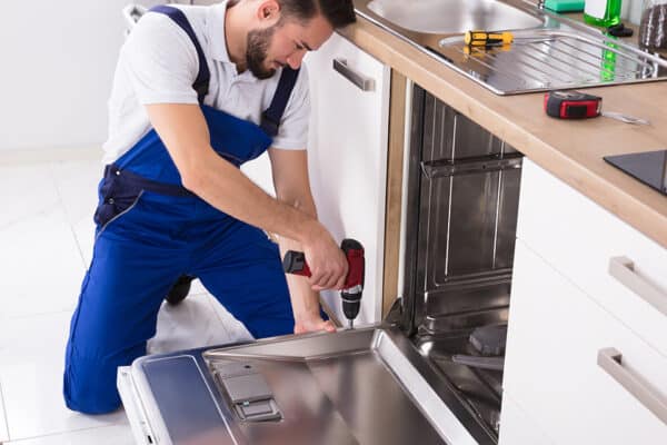 Technician uses services parts to repair a dishwasher